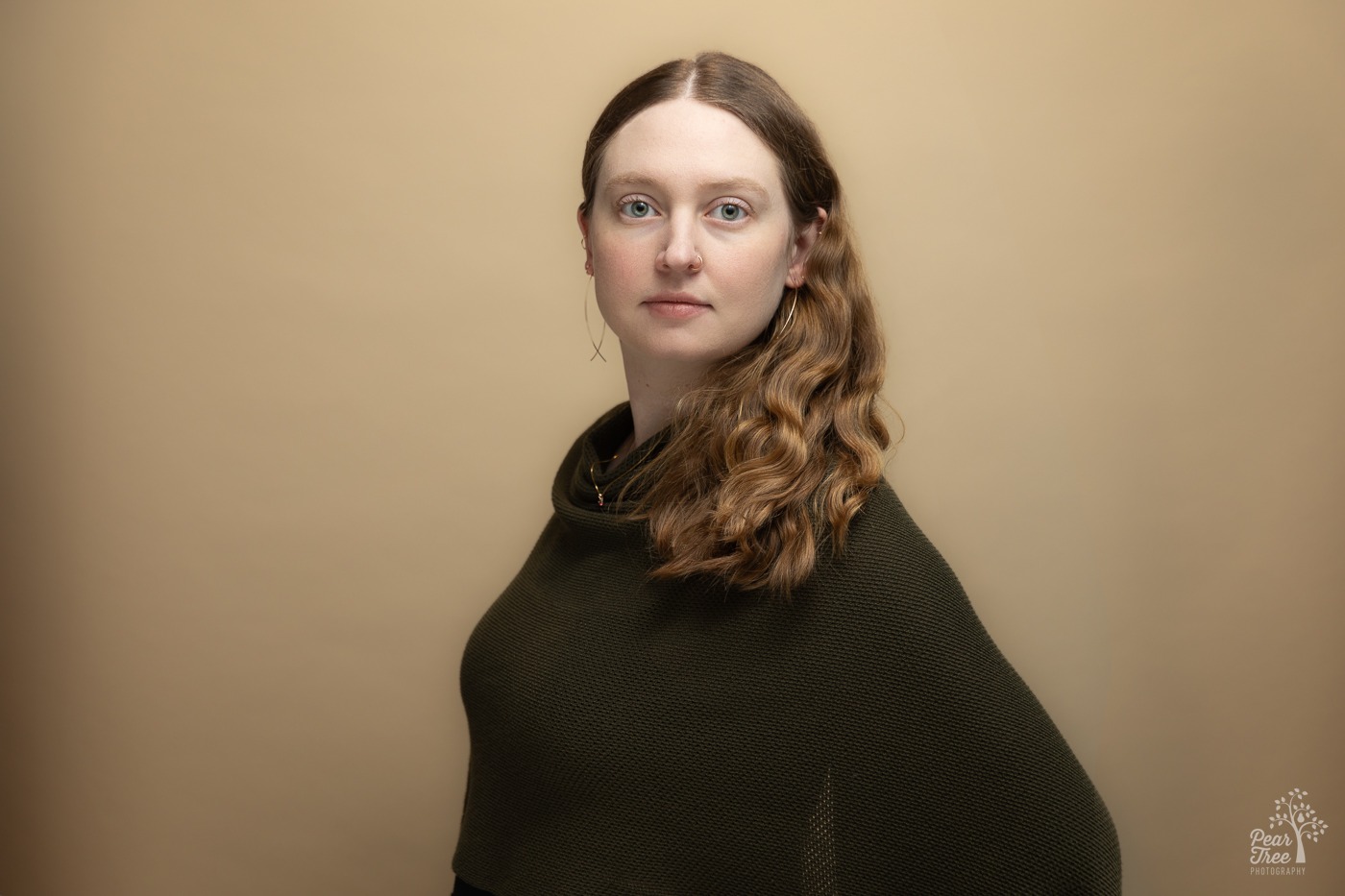 Professional portrait of Dr. Hillary Langley in front of a cream wall