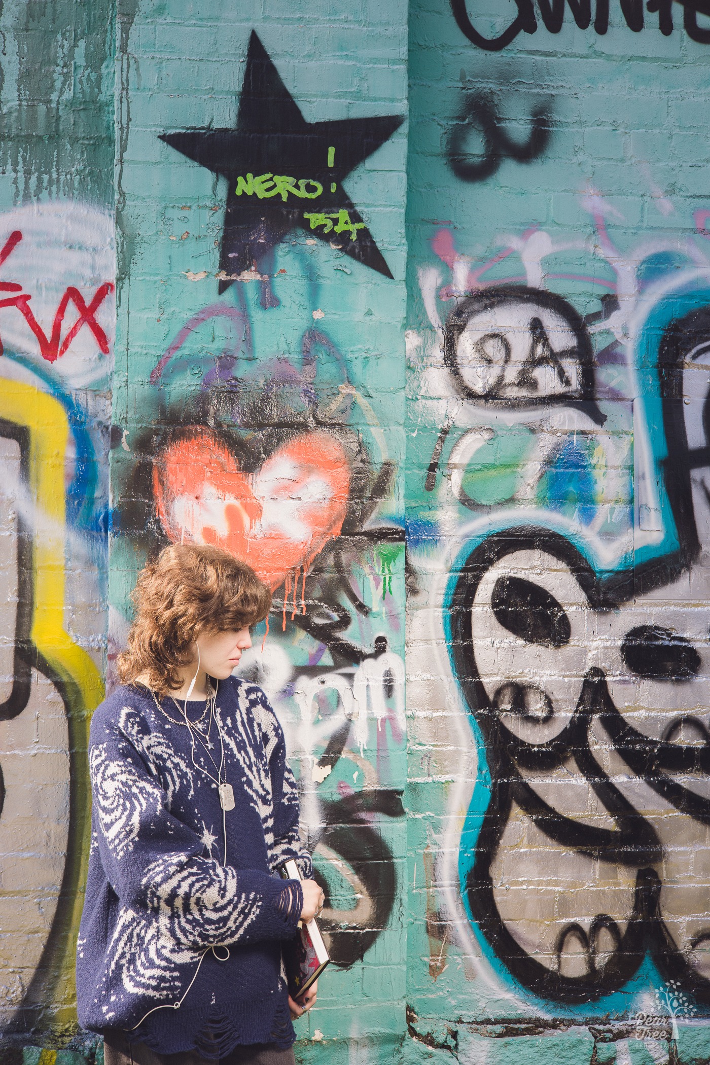 Little Five Points high school senior session in front of building covered in graffiti