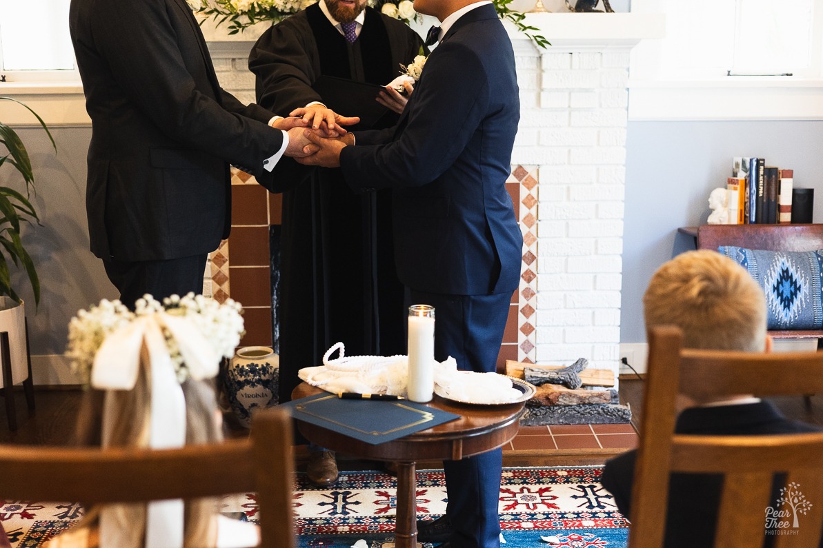 Two grooms holding hands in an intimate LGBT wedding ceremony in Midtown Atlanta