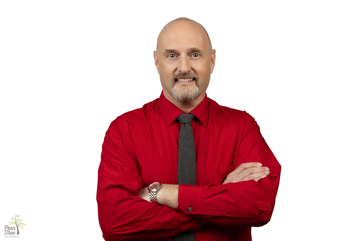 Local State Farm Agent with a goatee is wearing a red dress shirt and smiling with arms crossed