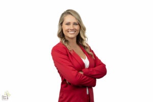 State Farm Agent Megan Green wearing a red blazer and white blouse in front of white background