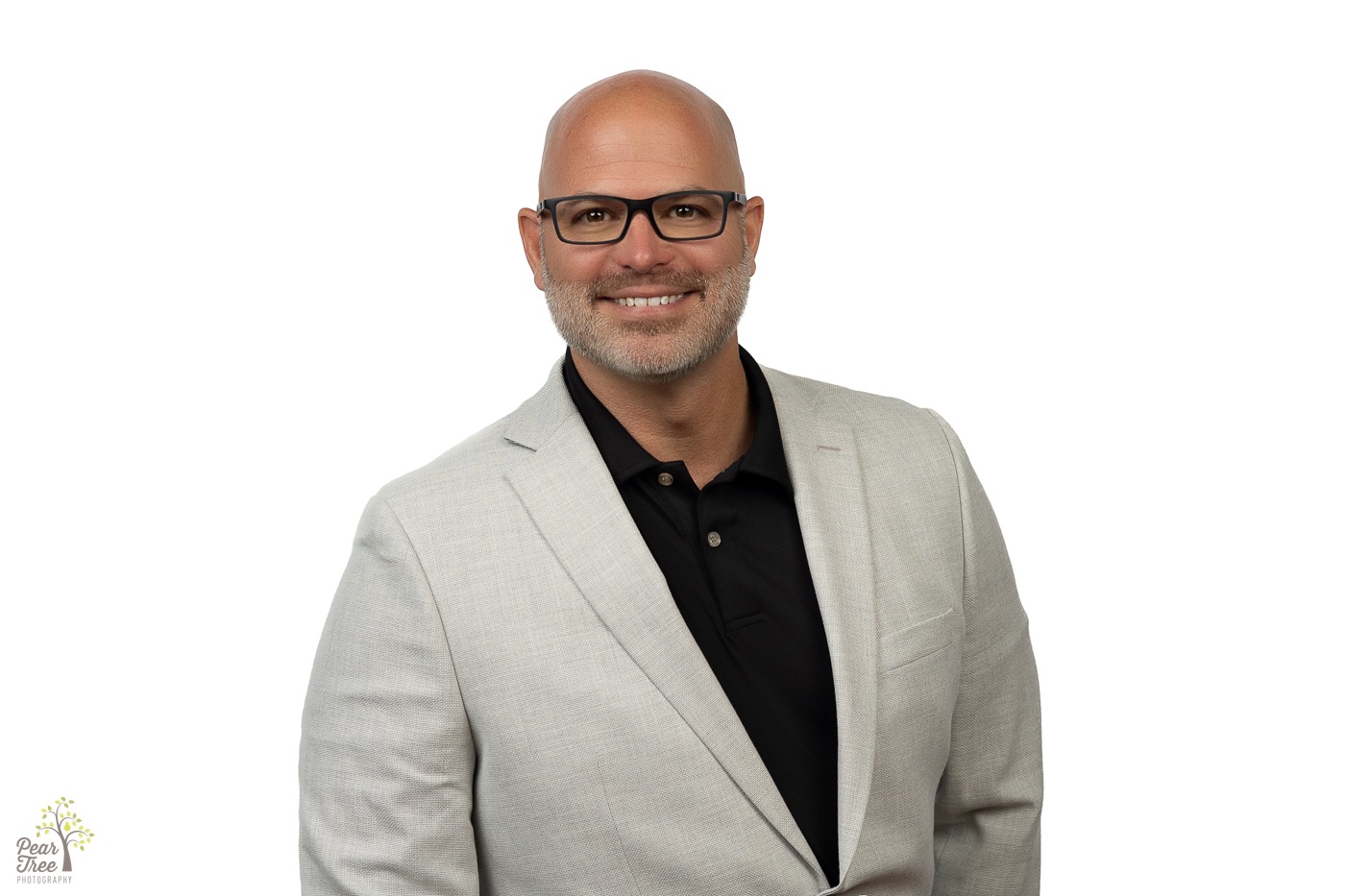 Local State Farm Agent Jeremy Green wearing a linen blazer, black polo, and black glasses for a professional headshot in Canton, GA