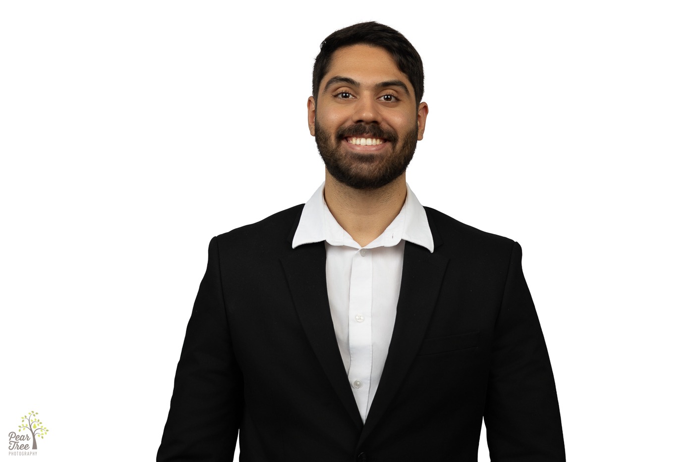 Smiling Latino agent for State Farm wearing a dark blazer and white button down shirt