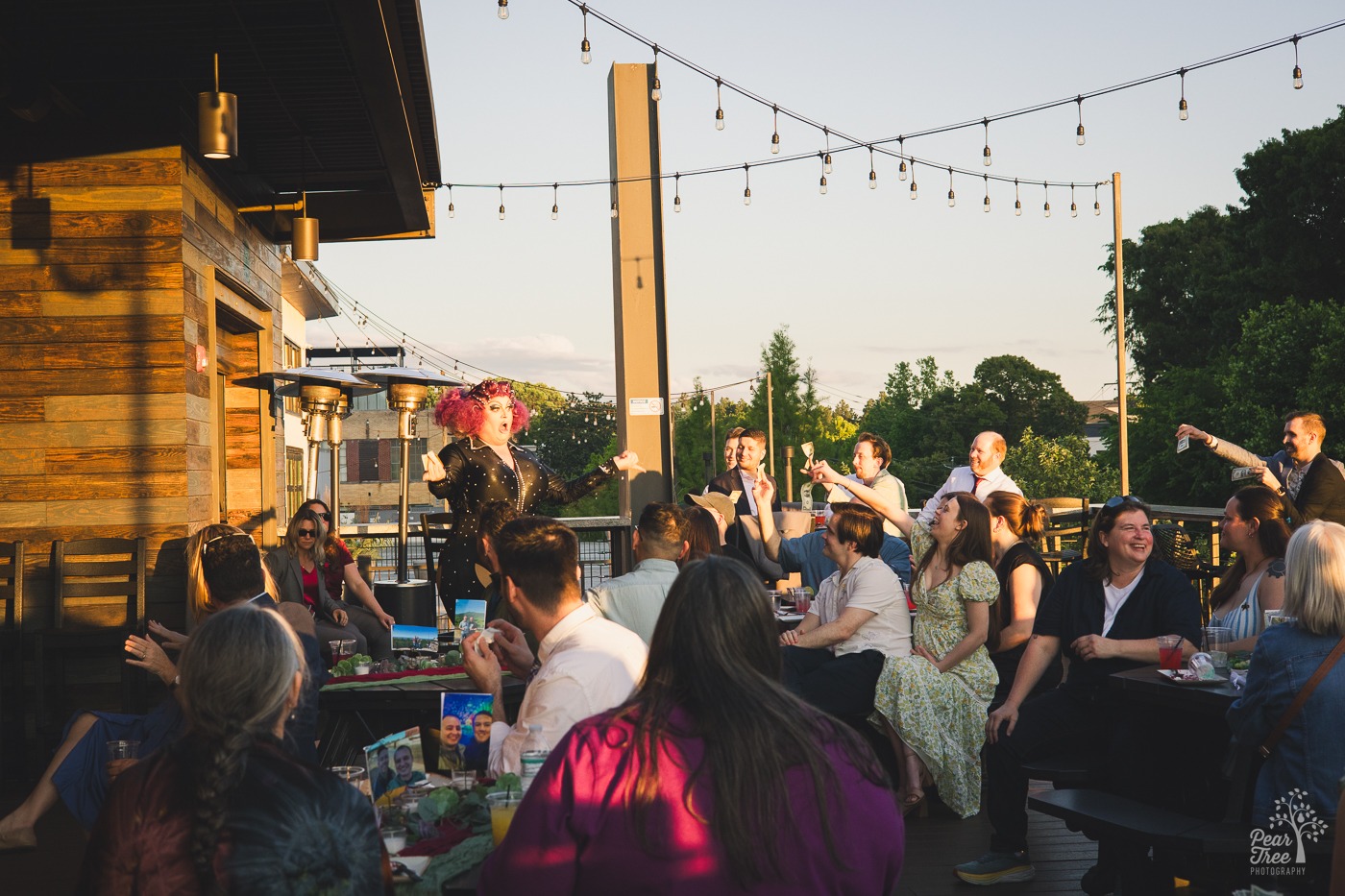 Atlanta drag queen Tugboat performing at a wedding reception on rooftop bar at New Realm Brewing Co.