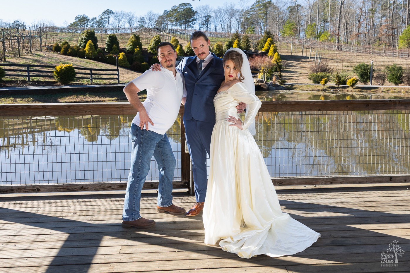 Sassy bride, groom, and friend posing together fiercely at Big Door Vineyards
