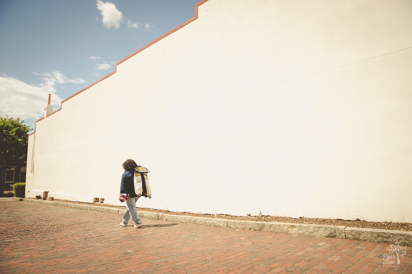 Etowah senior walking down a brick street in Marietta