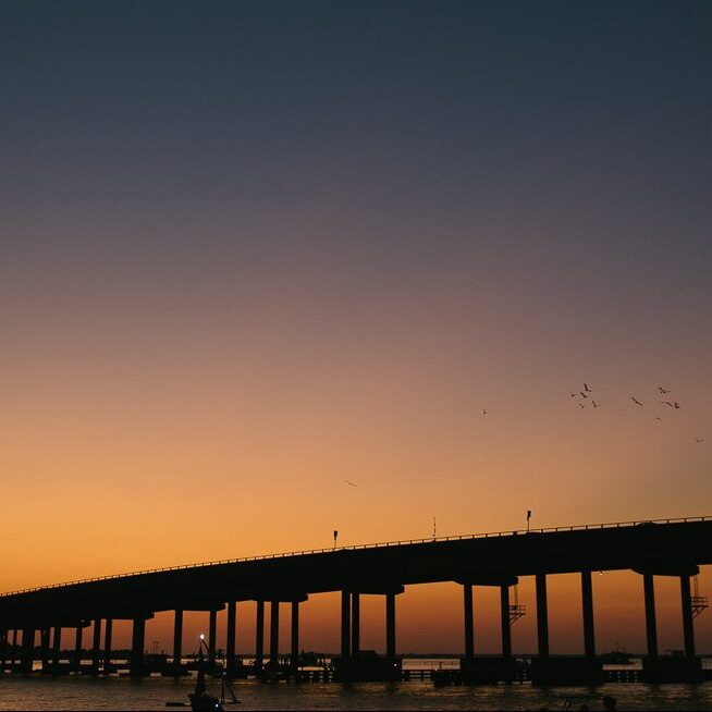 Sunset behind Destin bridge over Destin Harbor