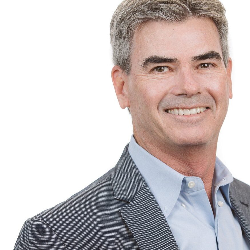 Headshot of Steve Manley in blue shirt and grey jacket