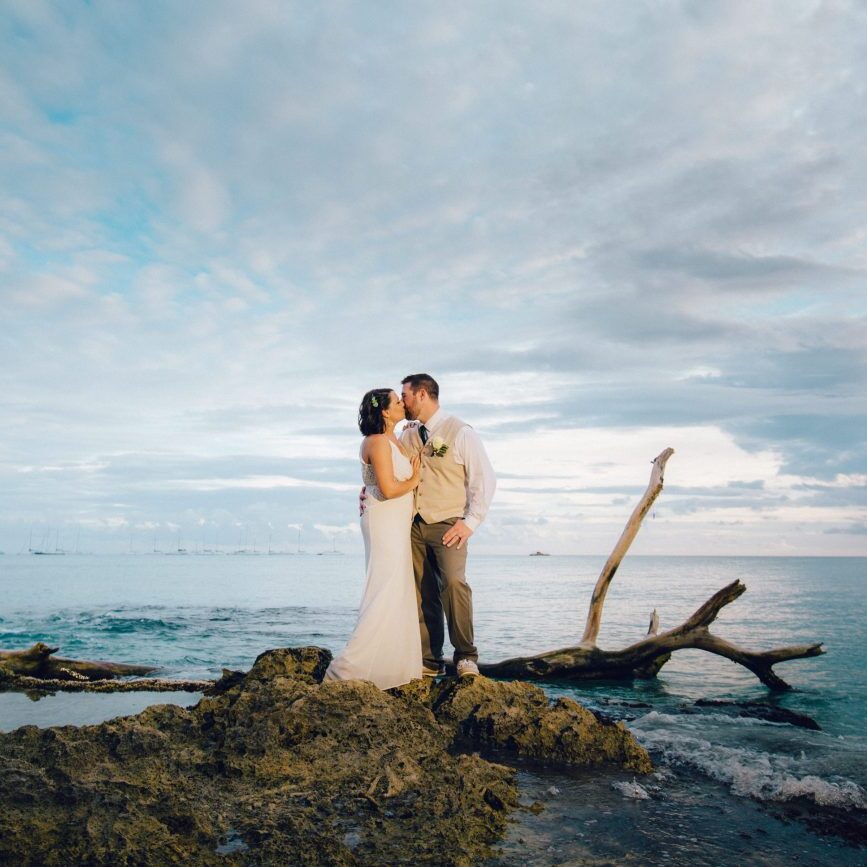 Bride + Groom kissing on Dominican Republic beach after their destination wedding