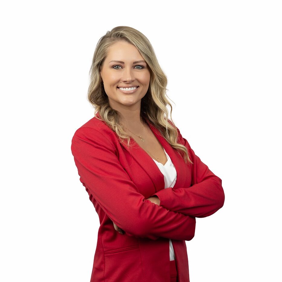 State Farm Agent Megan Green wearing a red blazer and white blouse in front of white background