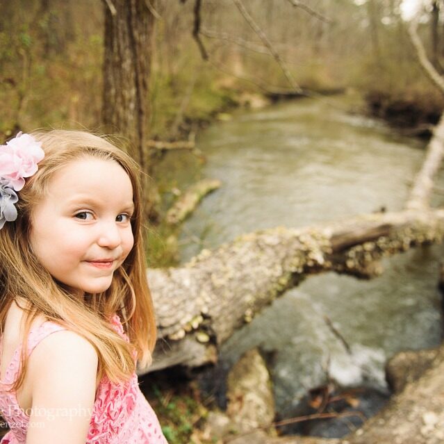 Cute little blond girl shyly smiling at Line Creek in Peachtree City