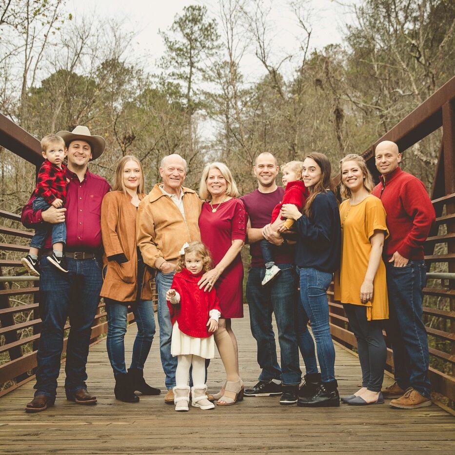 A multi-generational family photo at Olde Rope Mill Park on the metal bridge