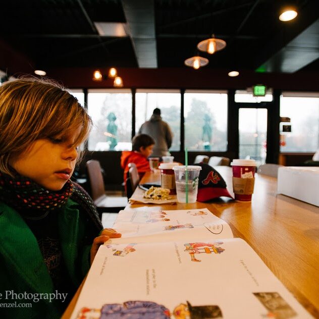 little girl sitting at restaurant counter